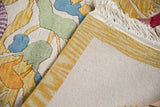Tightly woven backside of the vintage Indian Art Deco rug and its yellow striped side cord.