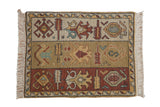 Vintage Armenian sampler rug with a triple-banded design of geometric motifs in copper, saffron, and ivory.