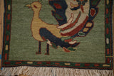 Pictorial Armenian peacock rug lower corner, jade green field, boteh border, ivory fringe.