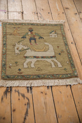 Armenian pictorial rug featuring horse trainer, house, and jade green vine border.