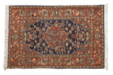 Vintage Armenian Hamadan rug with a navy blue floral field, central medallion, and chestnut rust borders.