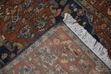 Folded corner of a vintage Armenian rug reveals its hand-knotted back and full pile.