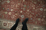 Close view of the full pile and dense floral boteh pattern on a copper-red vintage Armenian rug.