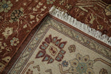 Close-up of the vintage carpet's corner showing the dense copper pile, beige border, and hand-knotted back.