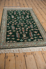 Traditional style vintage Armenian Hamadan rug with deep emerald green field and colorful floral vines.