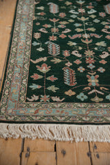Vintage Armenian Hamadan rug side selvage, fringe, and emerald field with blush, blue motifs.