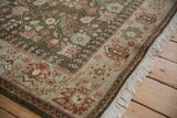 The corner of a vintage Armenian rug, showing its intact selvage, full pile, and clean fringe.