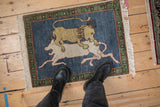 Pictorial Armenian hunting scene rug, beige lion preying on ivory against dark denim blue.