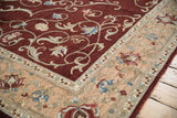 Corner of an Armenian Arts and Crafts carpet with a plush wine-red pile and a sand floral border.