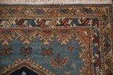 Corner of a vintage Hamadan rug showing geometric borders with serrated leaves and intact fringe.
