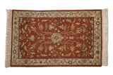 Vintage Lilihan design rug with a central palmette and floral vines in copper, teal, and saffron tones.