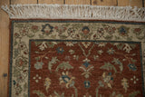 Corner of a vintage Armenian rug with a plush wool pile, detailed floral border, and clean ivory fringe.