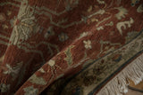 The soft, full wool pile of a vintage Armenian rug folded to reveal its texture and ivory fringe.