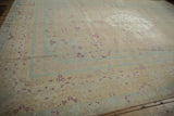Even wear across knot heads on a distressed vintage carpet with scattered magenta floral details.
