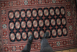 A personal perspective of the dense wool pile and repeating gul medallions on a fine Bokhara rug.