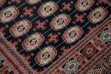 Tight weave showing geometric gul medallions and an intricate border on a fine Bokhara rug.