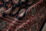 The plush, silk-like wool pile and intricate gul medallions of a vintage Bokhara rug.