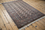Angled view of a fine Bokhara rug, highlighting its lustrous wool pile and repeating gul pattern.
