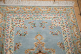 White fringe and Kerman design floral border with pastel blossoms on ivory.