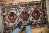 Vintage Indian Caucasian rug corner with multi-cartouche and serpent borders in rust, navy, sky blue.