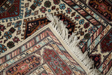 Original fringe and intact selvage of a vintage Indian Caucasian rug, with multi-cartouche geometric borders.