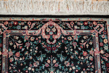 White fringe and detailed floral bouquets on dense black pile of a vintage Savonnerie design rug.