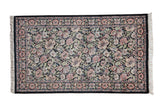 Vintage Pakistani rug, dense Arts and Crafts floral vine pattern, black field, pink, ivory, green.