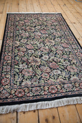 Ornate border and dense floral pattern of multi-petaled blossoms in dusty rose, green, and ivory.