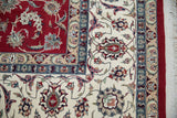 Pakistani Isfahan carpet corner: detailed floral field and main border in cherry red and ivory.