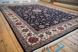 Vintage Pakistani Isfahan carpet: navy field, delicate blush floral vinery, ivory border, fringe.
