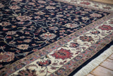 Vintage Isfahan design with navy floral field and ivory border showing blush palmettes.