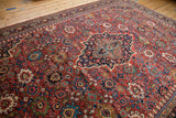 A vintage Mahal carpet's dense field of floral palmettes surrounding a navy blue shield-like center medallion.