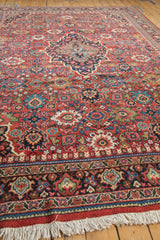 Angled view of a vintage Mahal carpet, emphasizing the detailed Samovar border and rich, floral rust field.