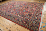 The intricate Samovar-style border and ivory fringe of a vintage hand-knotted Mahal carpet.