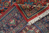 Corner of a vintage Mahal carpet showing the Samovar border, red selvage, and off-white fringe.