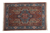Hand-knotted vintage Indian Serapi rug with central diamond medallion, floral arabesques, dark rose and denim blue.