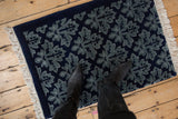 Plush, even pile of an Indian rug with a tone-on-tone blue Damask leaf design.