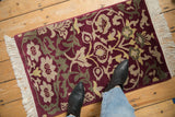 Indian Savonnerie rug: burgundy, beige, dusty green blossoms and scrolled vinery.