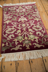 Burgundy, beige, dusty green Savonnerie design with germinating blossoms.
