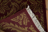 Hand-knotted back and carved pile of a vintage damask rug with original white fringe.