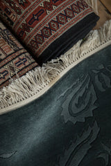 Minor stain on the plain weave border adjacent to the hand-knotted ivory fringe.