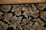 Corner detail of a vintage Indian rug, highlighting the carved pile and sprawling leaf design.