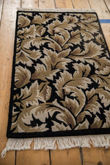 Angled view showcasing the carved texture and full pile of the vintage leaf-patterned rug.