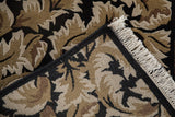 Folded corner of a vintage Indian rug showing the intact black selvage and neat ivory fringe.