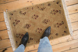 The carved, tone-on-tone texture of a vintage Indian Savonnerie design rug mat.