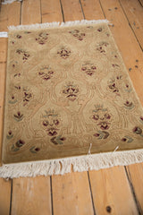 Low angle view of a vintage Indian rug highlighting the shallow carved contour of its lattice design.