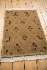 Shallow carved contour of a vintage Indian rug's tone-on-tone lattice and floral pattern.