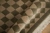 Shallow carved texture accentuating olive green and antique ivory checkered diamonds.