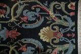 Savonnerie design looped pile showing black, denim blue, and cochineal floral scrolls with intact fringe.
