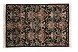 Vintage Indian Savonnerie rug, black field, Rococo urn, floral motifs, blush, green, blue.